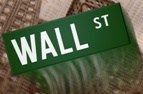 Wall Street – street sign with building and charts in the background